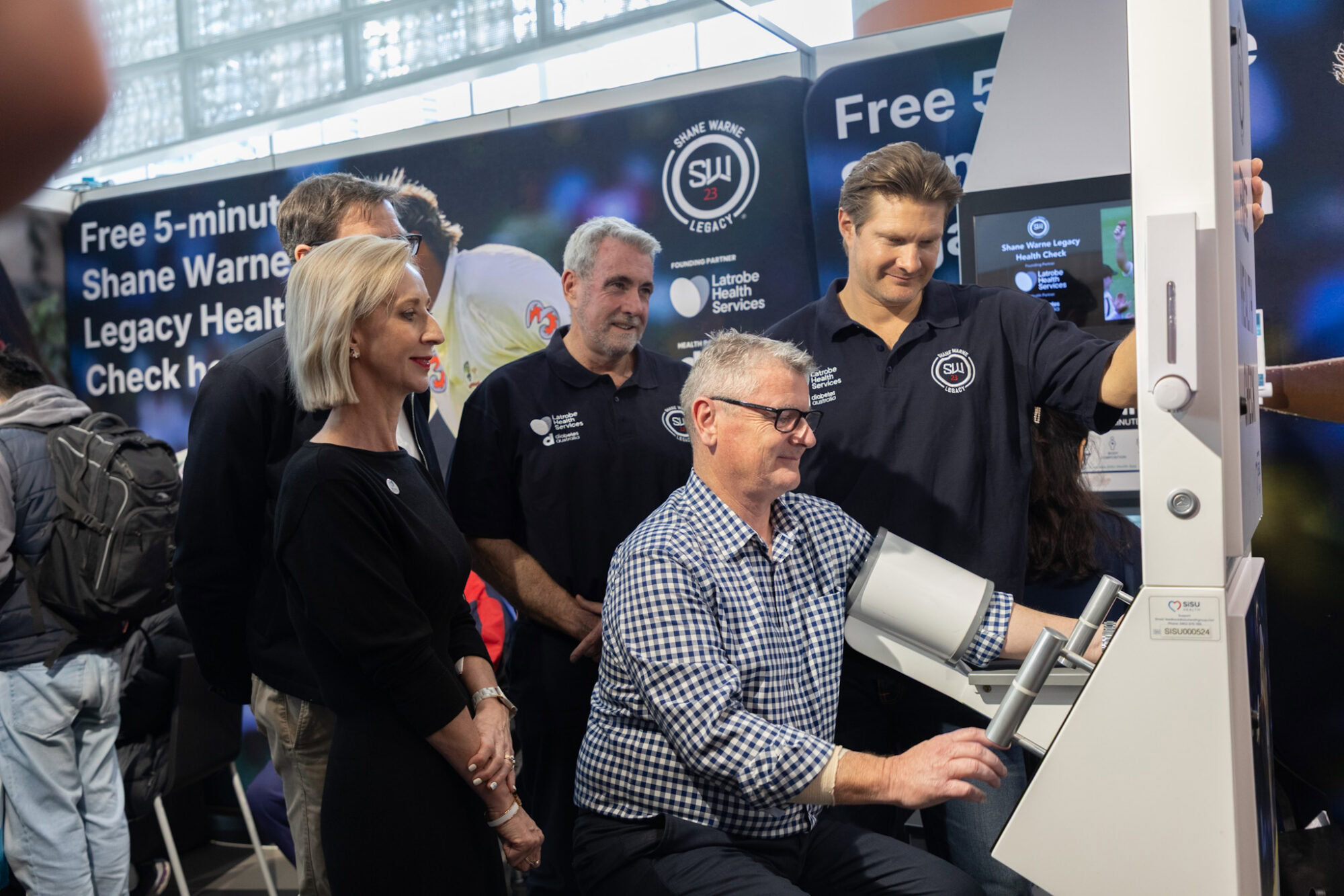 A group watches the 500,000th Shane Warne Legacy health check at the opening day of IDFWPR2026