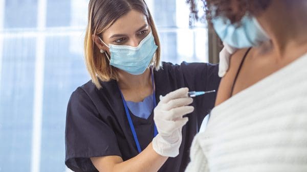 Nurse vaccinating patient