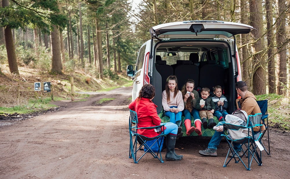 family having picnic back of van