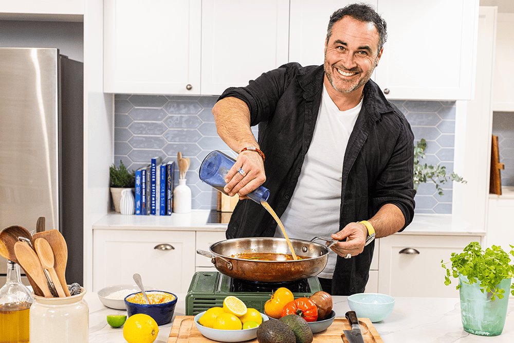 Miguel pouring liquid into a pan