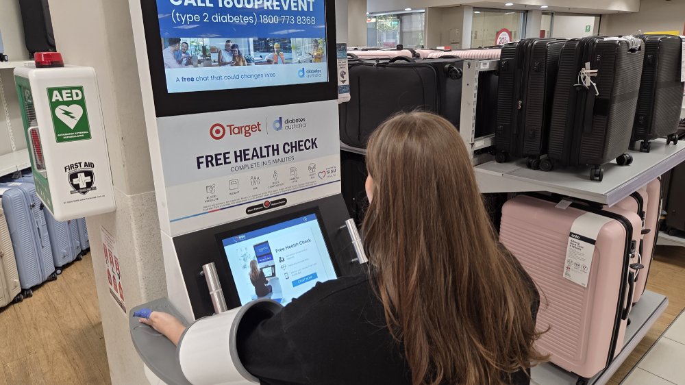 A customer using a SiSU Health Check machine in a Target store