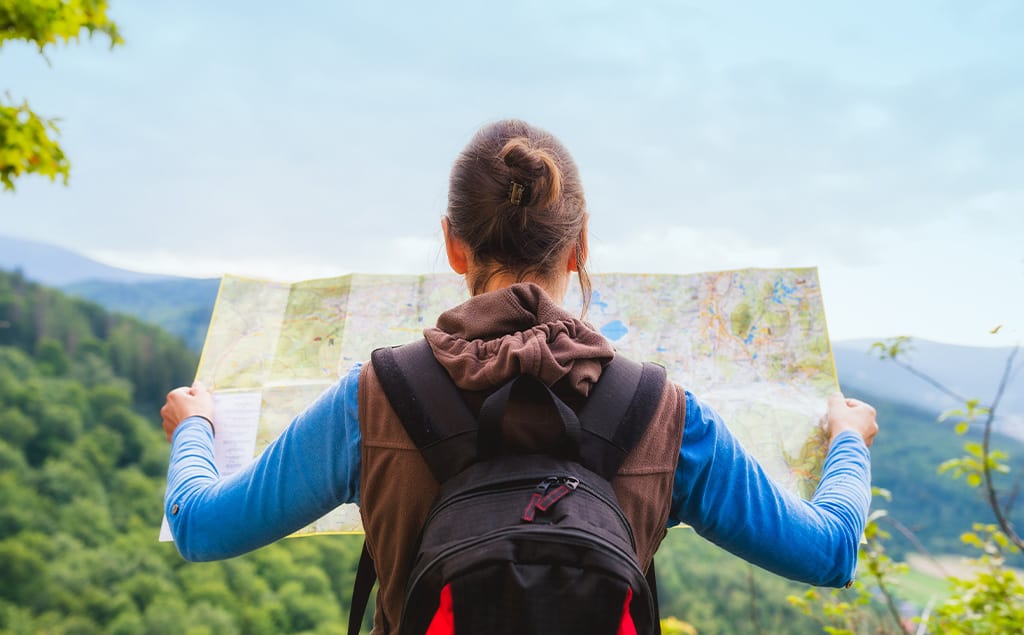 Back view of a woman with map