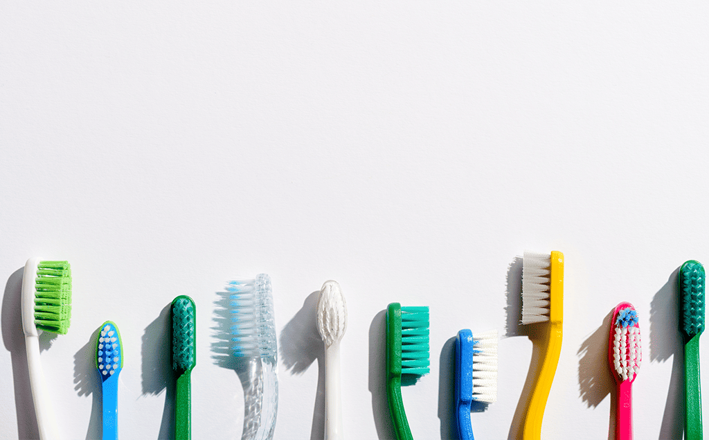 coloured toothbrushes on a white background