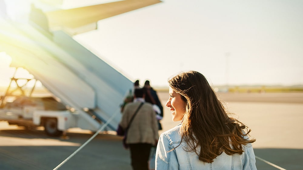 Woman walking onto a plane at the airport