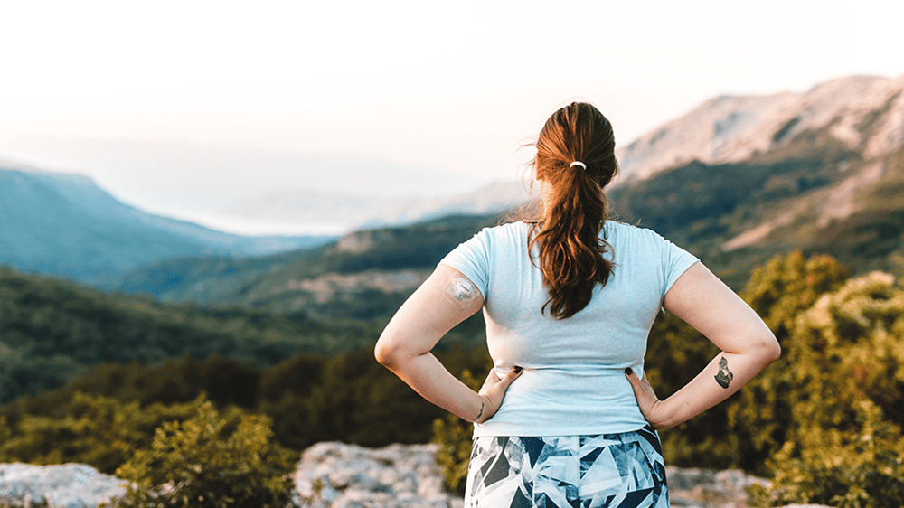 CGM woman at lookout during hike