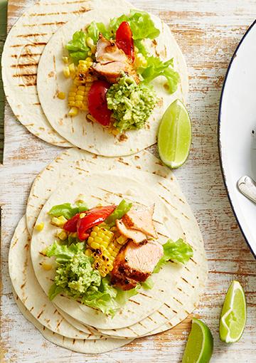 salmon tacos with guacamole and a slice of lime