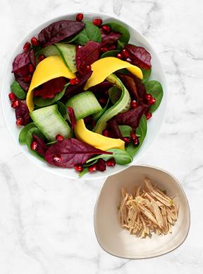 Turkey salad with spinach, cucumber, herbs, mango and pomegranate
