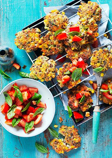 corn and broccoli fritters with tomato and basil on a cooling rack