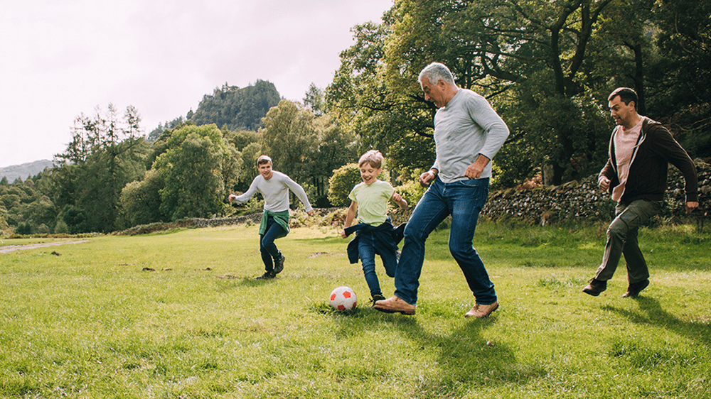 exercise, three generations playing football in the park