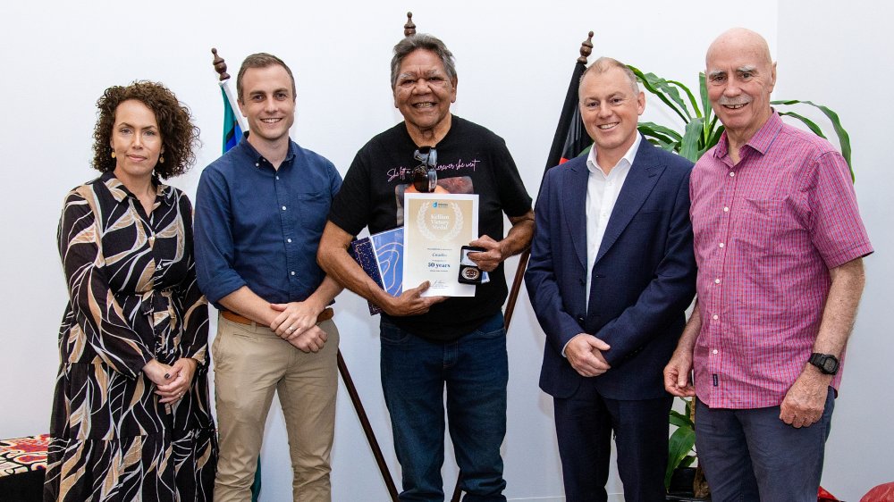 Gerald Buckle with Kellion Victory Medal, Matt Hare, Menzies School of Health Research, and DA staff.