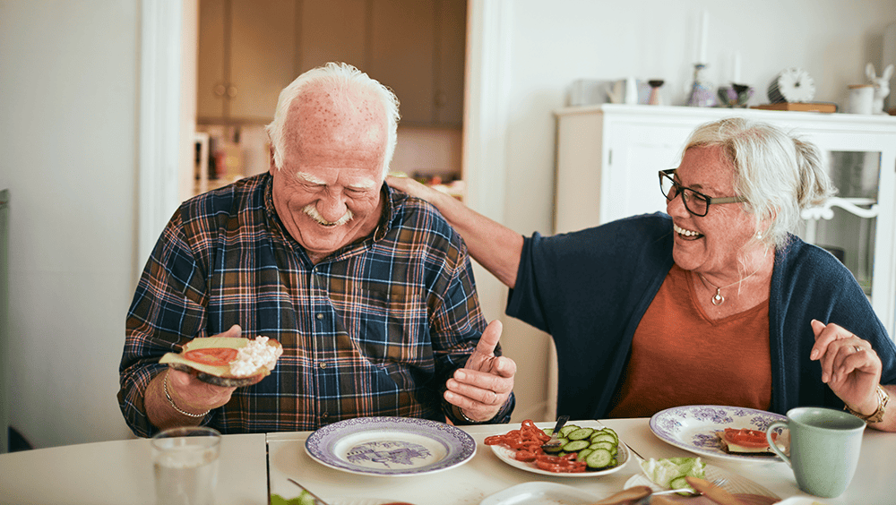 happy older couple eating lunch