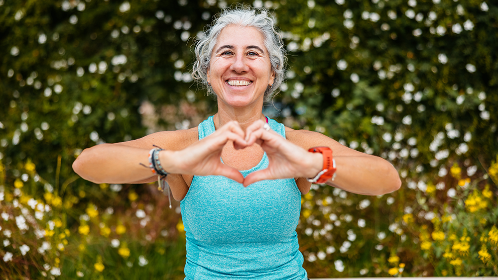 happy woman making heart shape with hands