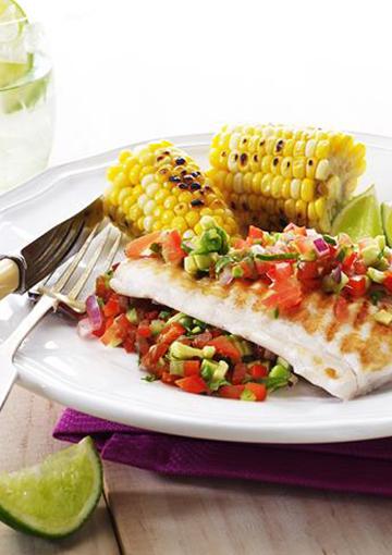 grilled fish with corn on the cob and topped with salsa
