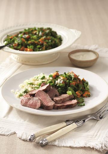 Grilled Lamb with vegetable tabouli on white plates