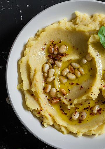 hommus topped with pine nuts and olive oil