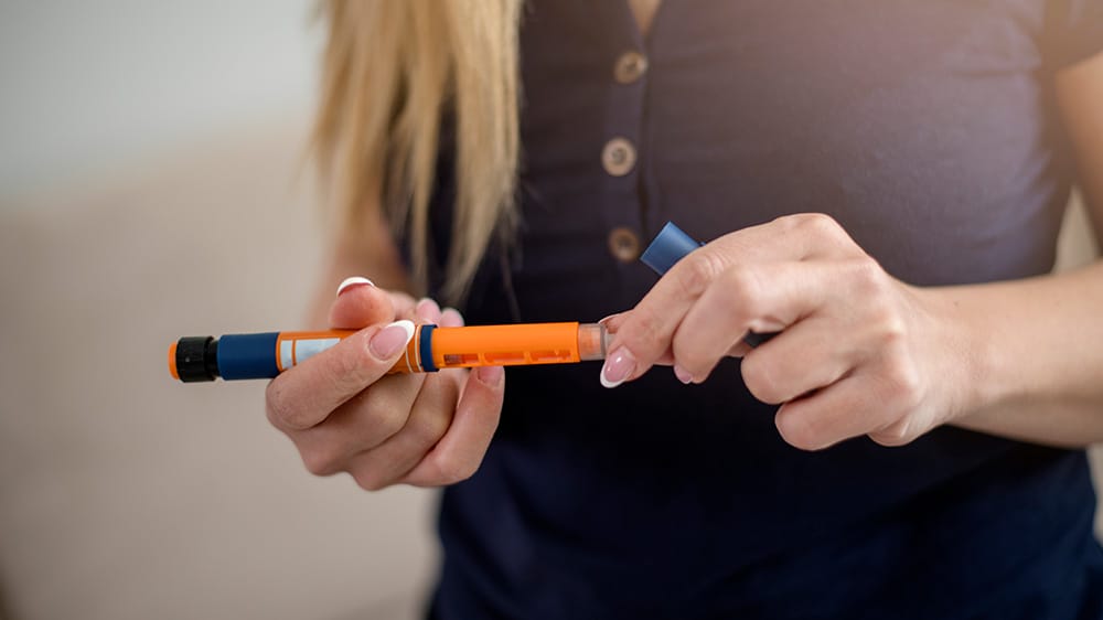 Woman using insulin pen