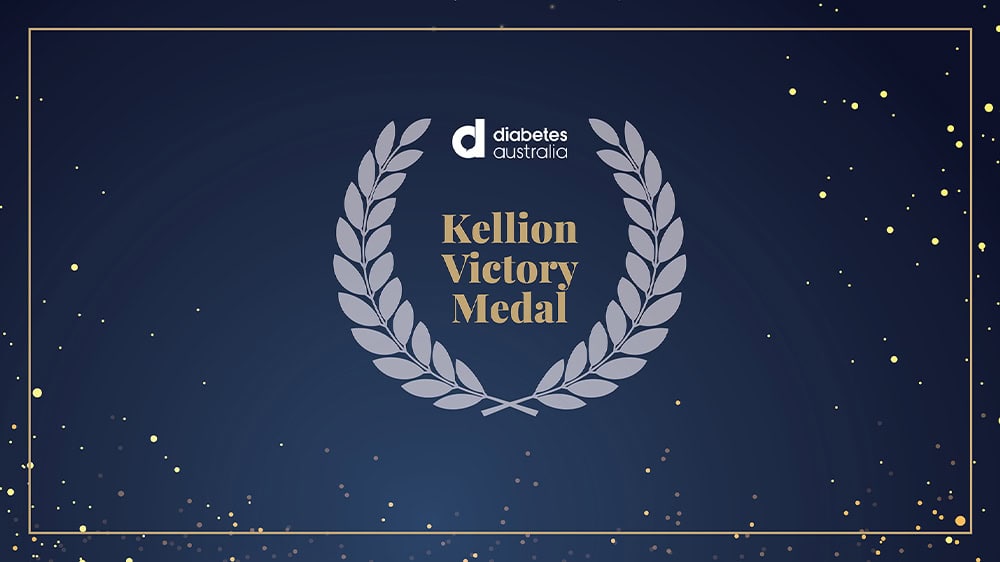 Sign of Kellion Victory Medal on a black background with stars and a grey laurel wreath