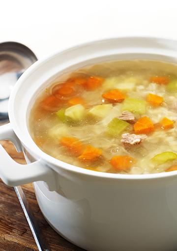 Barley soup with lamb in a white serving dish