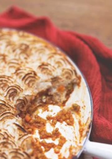 shepherd's pie in a baking dish on a red towel