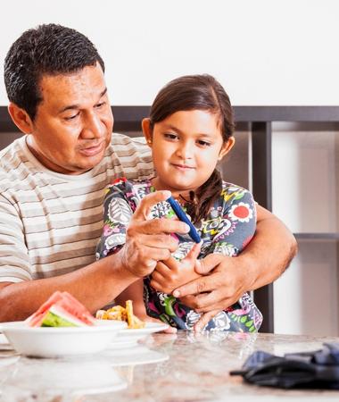 man and child monitoring blood glucose levels