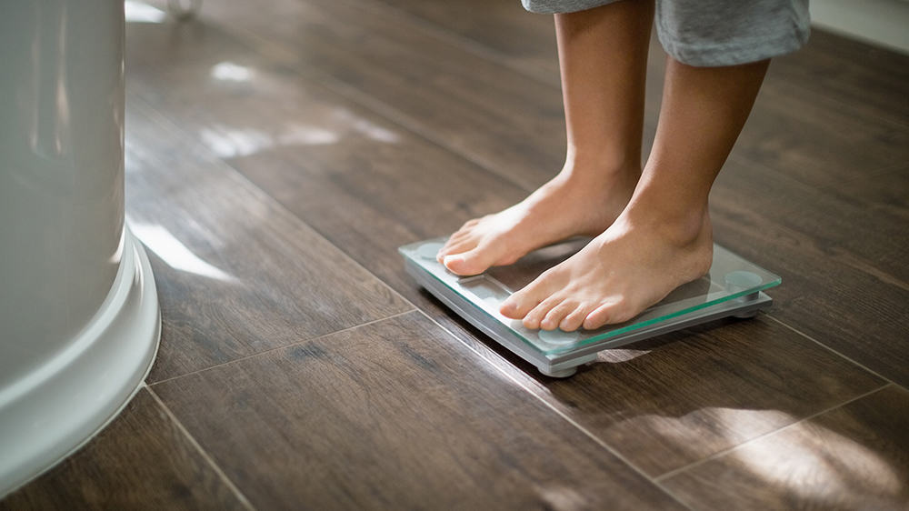 weight loss standing on scales