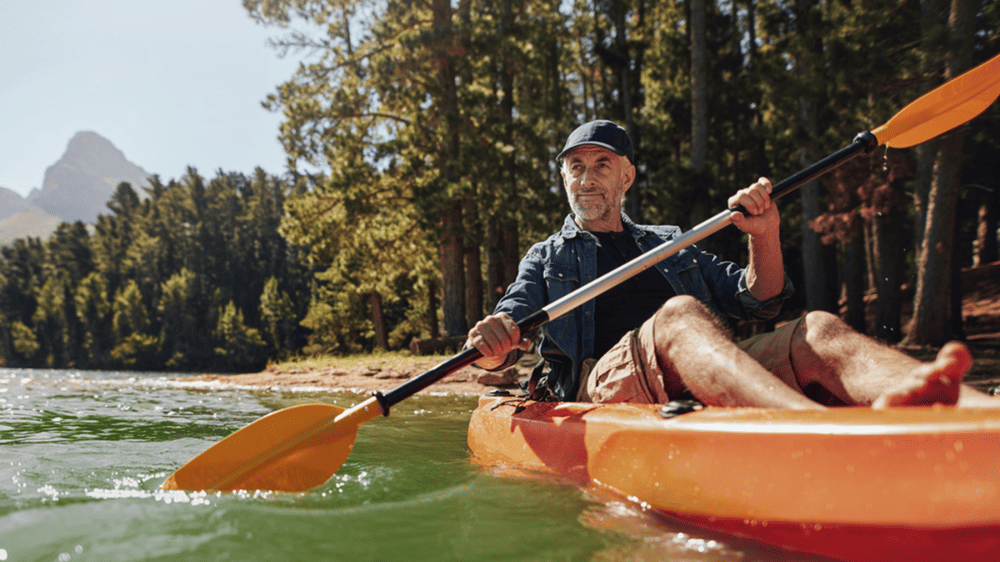 Attractive middle aged man in an orange canoe