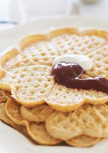 Waffles topped with jam and cream