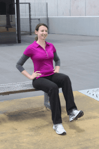 woman seated on bench one leg lifted