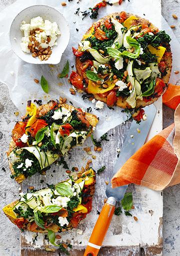 Veggie pizzas topped with ricotta, pine nuts and basil