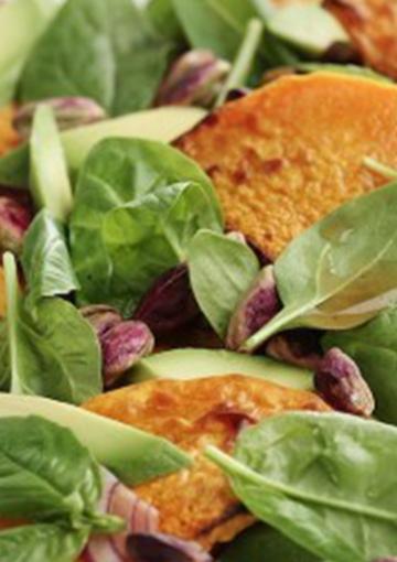 Pumpkin and pistachio salad topped with spinach