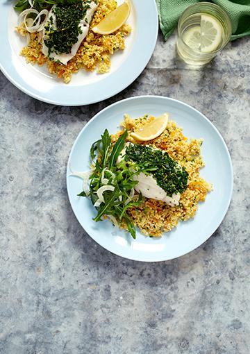 fish with couscous and salad topped with fennel and lemon wedges