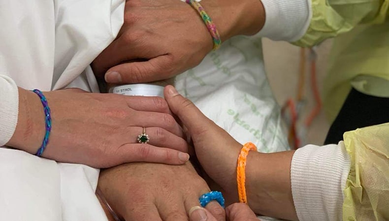 Stindl family holding hands at hospital