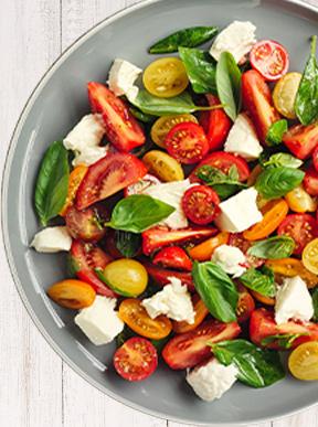 Tomato Medley Salad topped with basil in a bowl