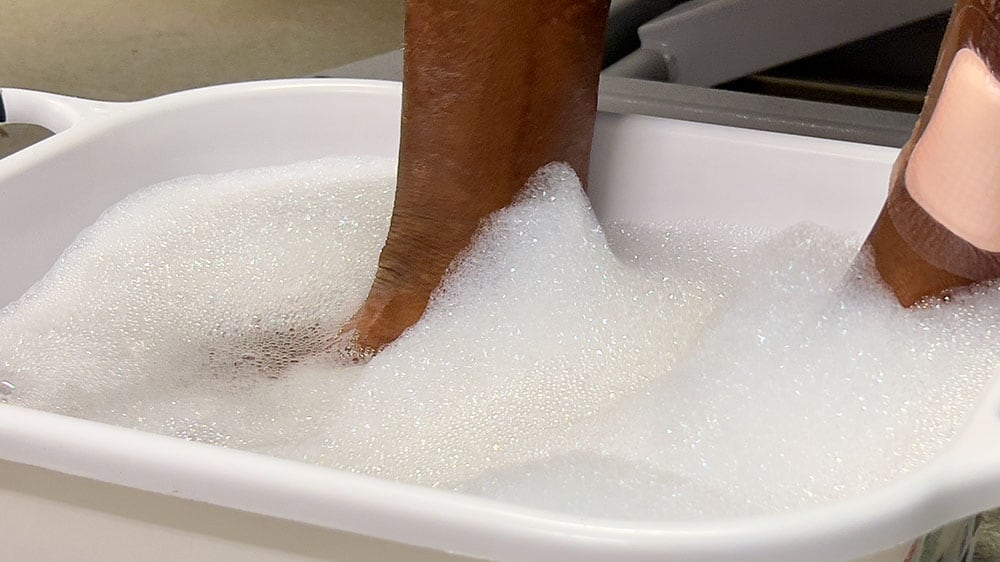 Feet being washed in soapy water