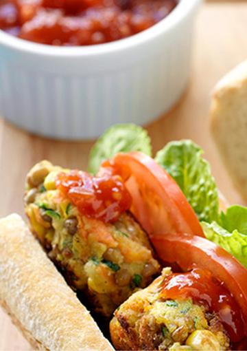 vegetable burgers with sliced tomato, lettuce and salsa