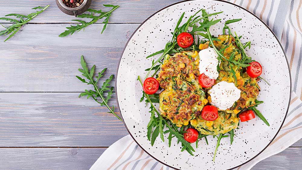 Zucchini pancakes with corn, served with salad