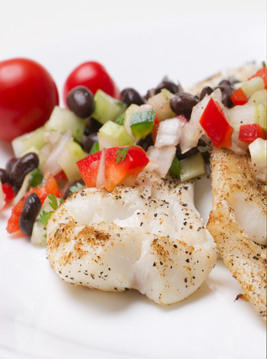 Barramundi with salad on a plate
