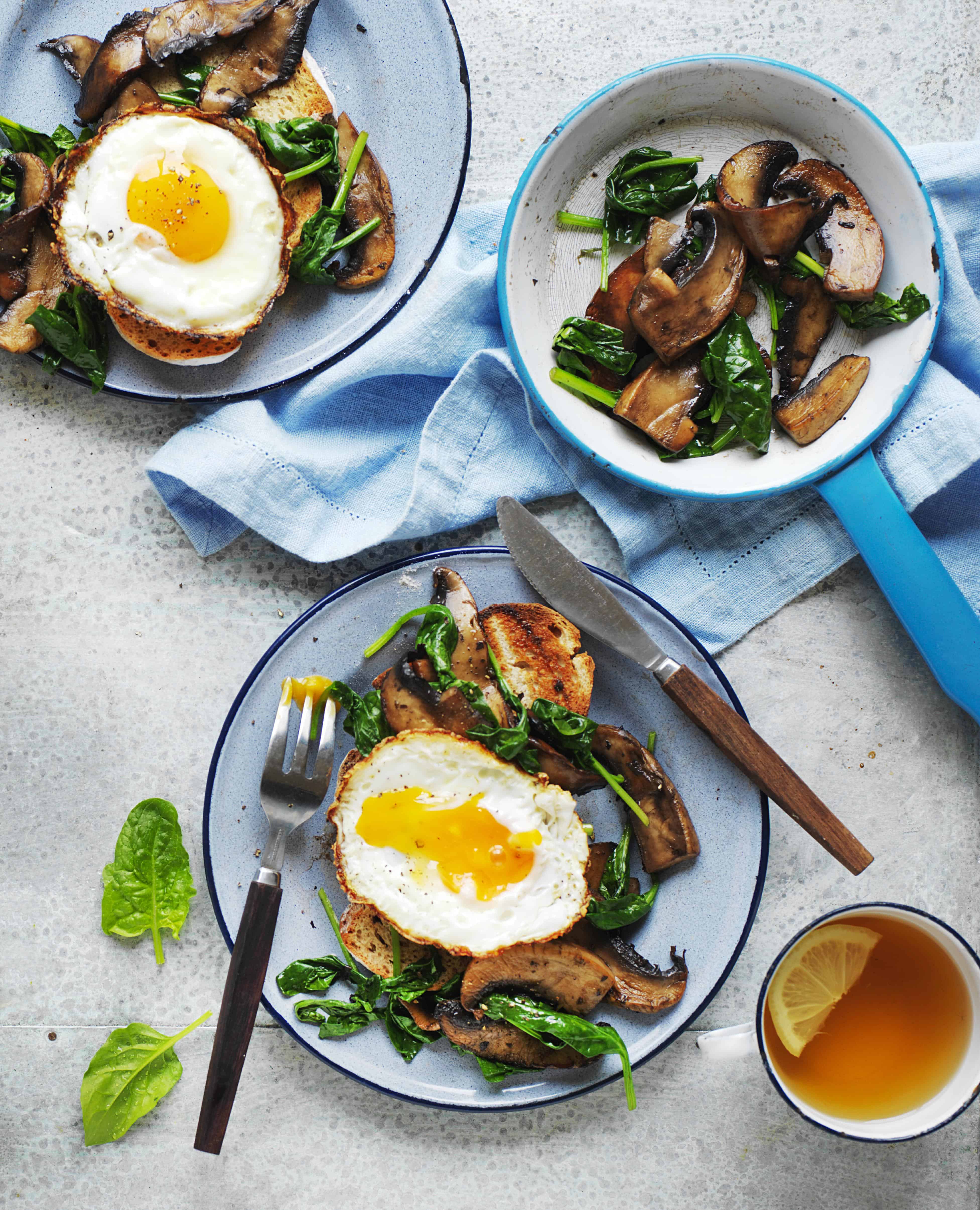 Fried egg with mushrooms and spinach with a cup of lemon tea