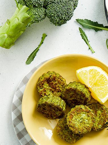 broccoli nuggets with a slice of lemon on an orange plate