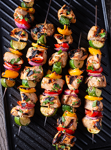 Spiced pork skewers on grill