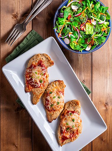 Fish parmigiana on a plate, ready to eat