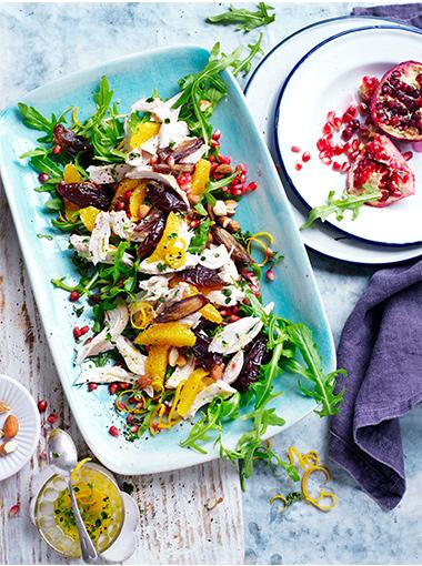 Chicken and date salad on a bed of rocket