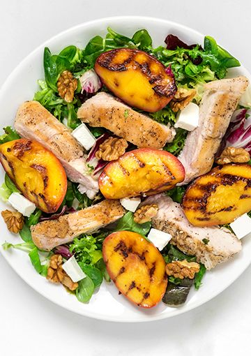 Chicken, peach and feta salad on a plate, ready to be eaten