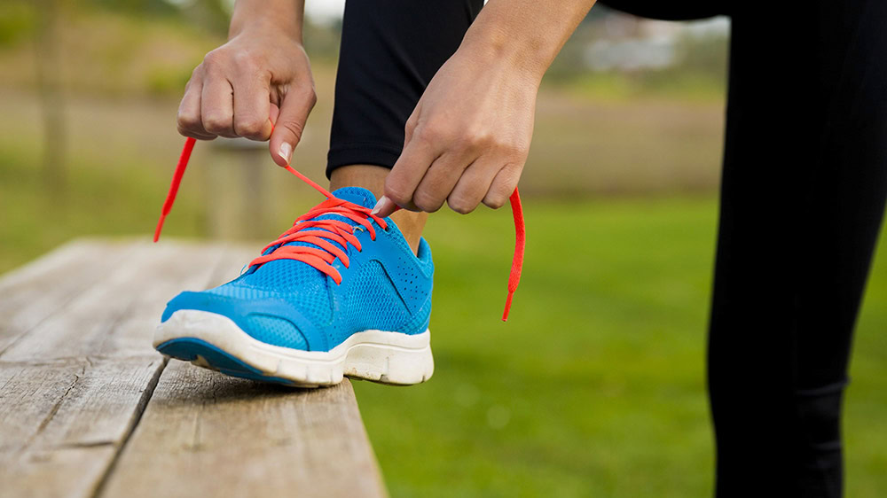 Close up photo of someone tying their shoes