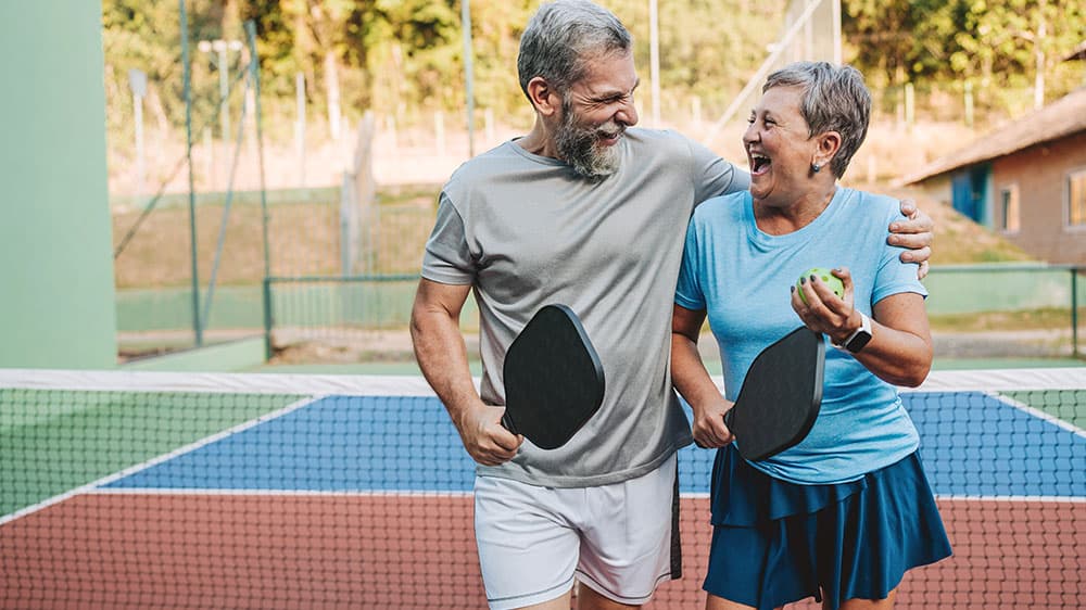 Couple playing pickleball