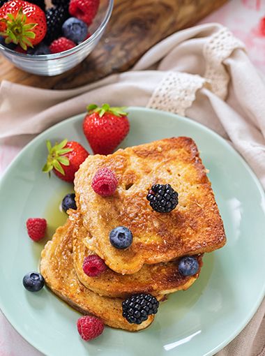 Eggy bread stacked on a plate, ready to eat