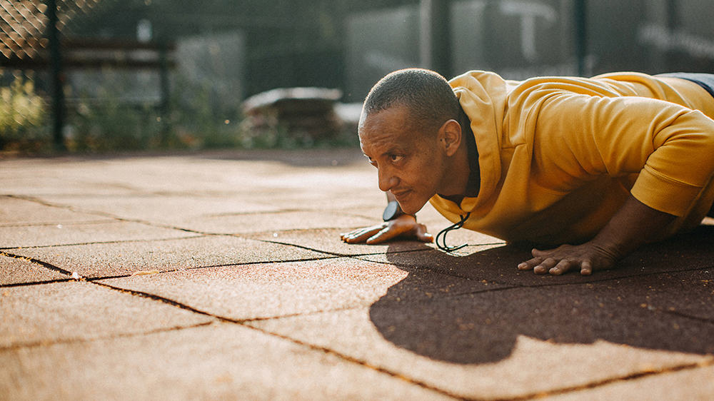 exercise myths, man doing pushups in a yellow jumper