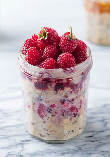 Festive-themed Bircher muesli in a container with berries, ready to be eaten
