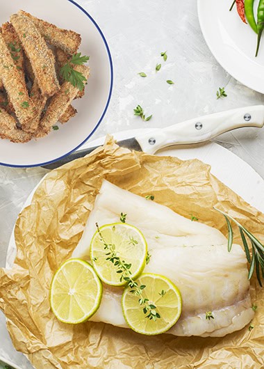 Cod fillets with vegetables before cooking in parchment paper