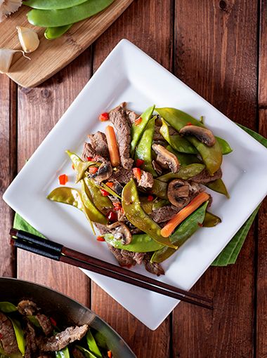 Ginger beef and almond stir fry on a plate, ready to eat